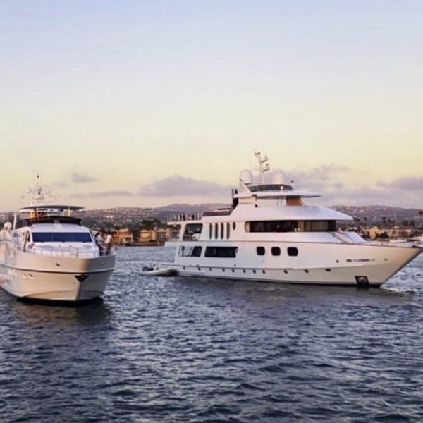 AURORA and Marbella cruising side by side at sunset, showcasing the elegance of our private yacht fleet.